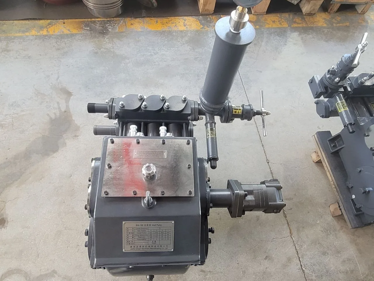 Top view of a reciprocating mud pump and mounted accessories